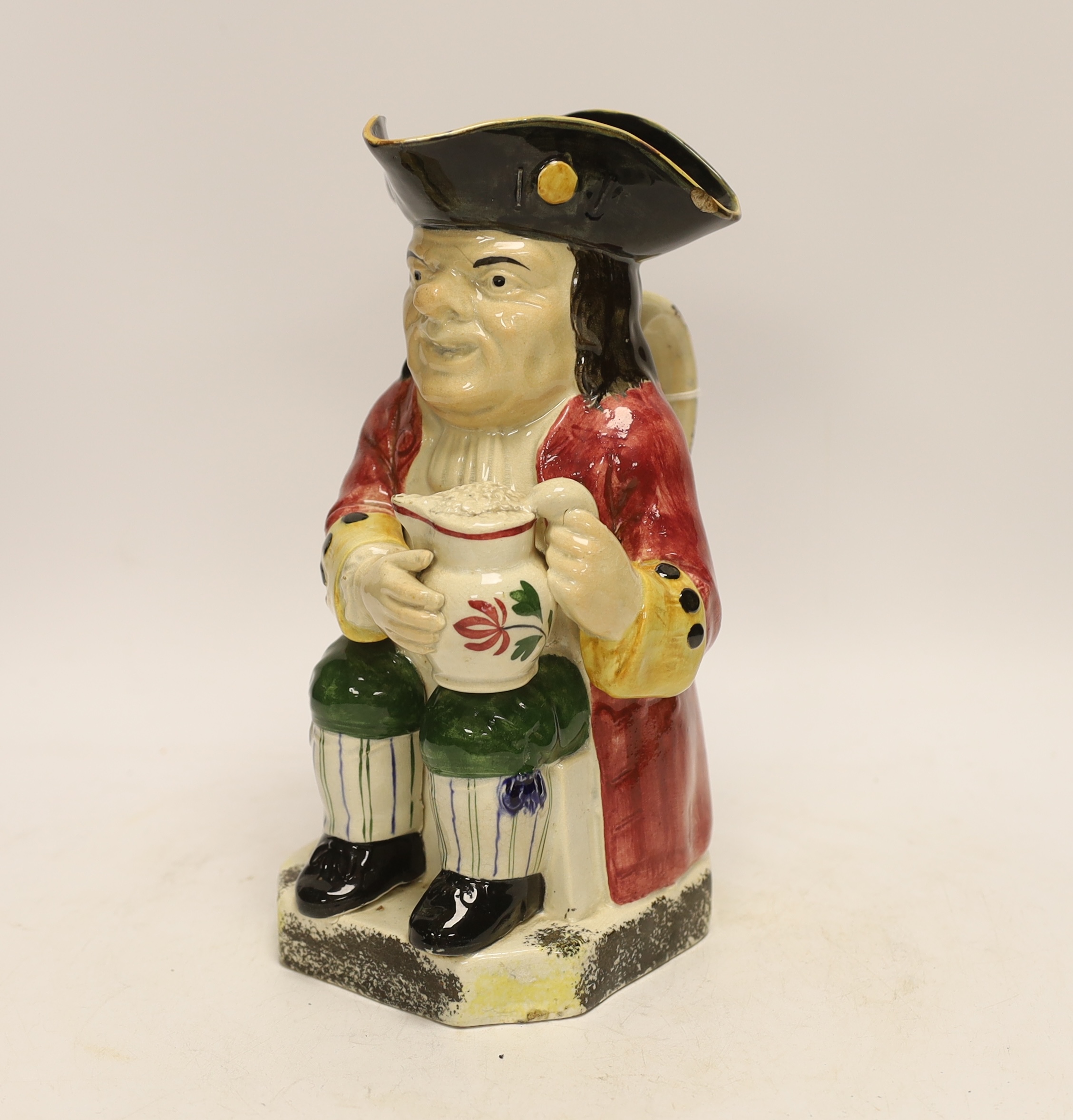 A Yorkshire Toby jug, c.1800, modelled holding a frothing jug, pink coat and green breeches, 26.5cm high